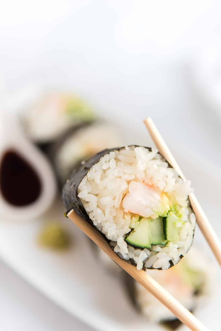 shrimp sushi with chopsticks.