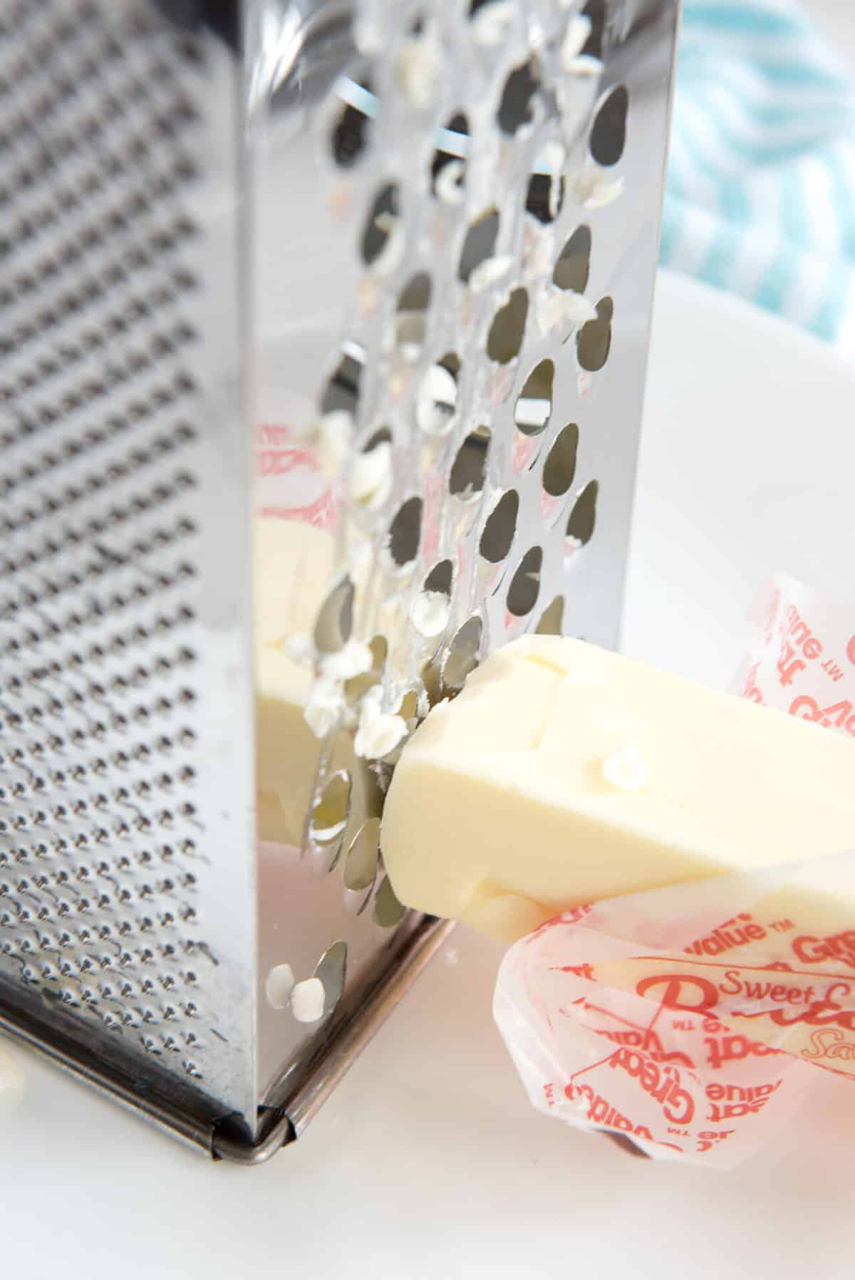 grading a hard butter stick with a cheese grater