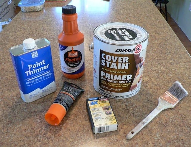 supplies for how to paint furniture tutorial including paint thinner, primer, paint brush and other supplies.