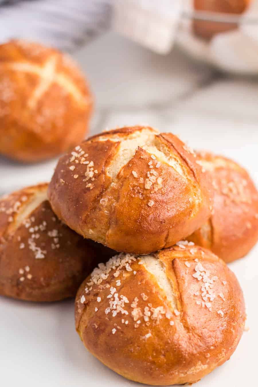 A pile of homemade pretzel rolls sprinkles with pretzel salt and baked until golden brown.