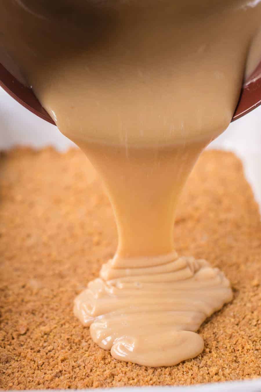 gooey caramel being poured over crisp crumbly tart bottom.