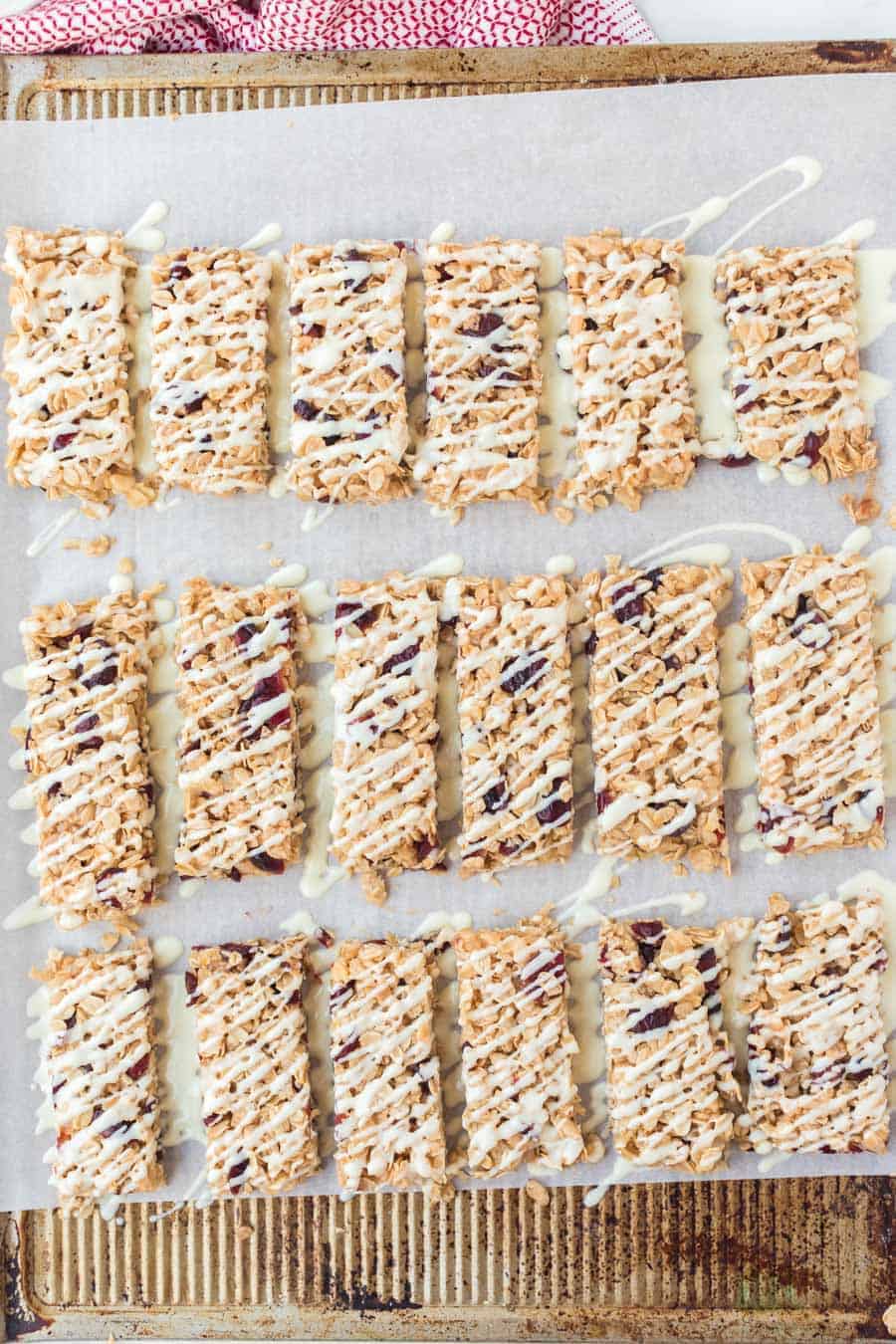 rectangles of cranberry granola bars on parchment.