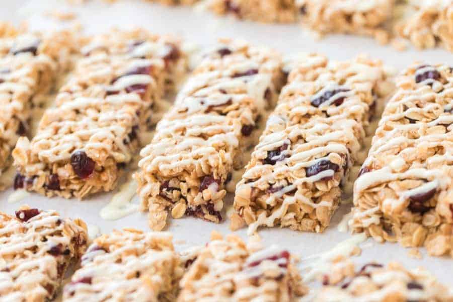 rectangles of cranberry granola bars on parchment.