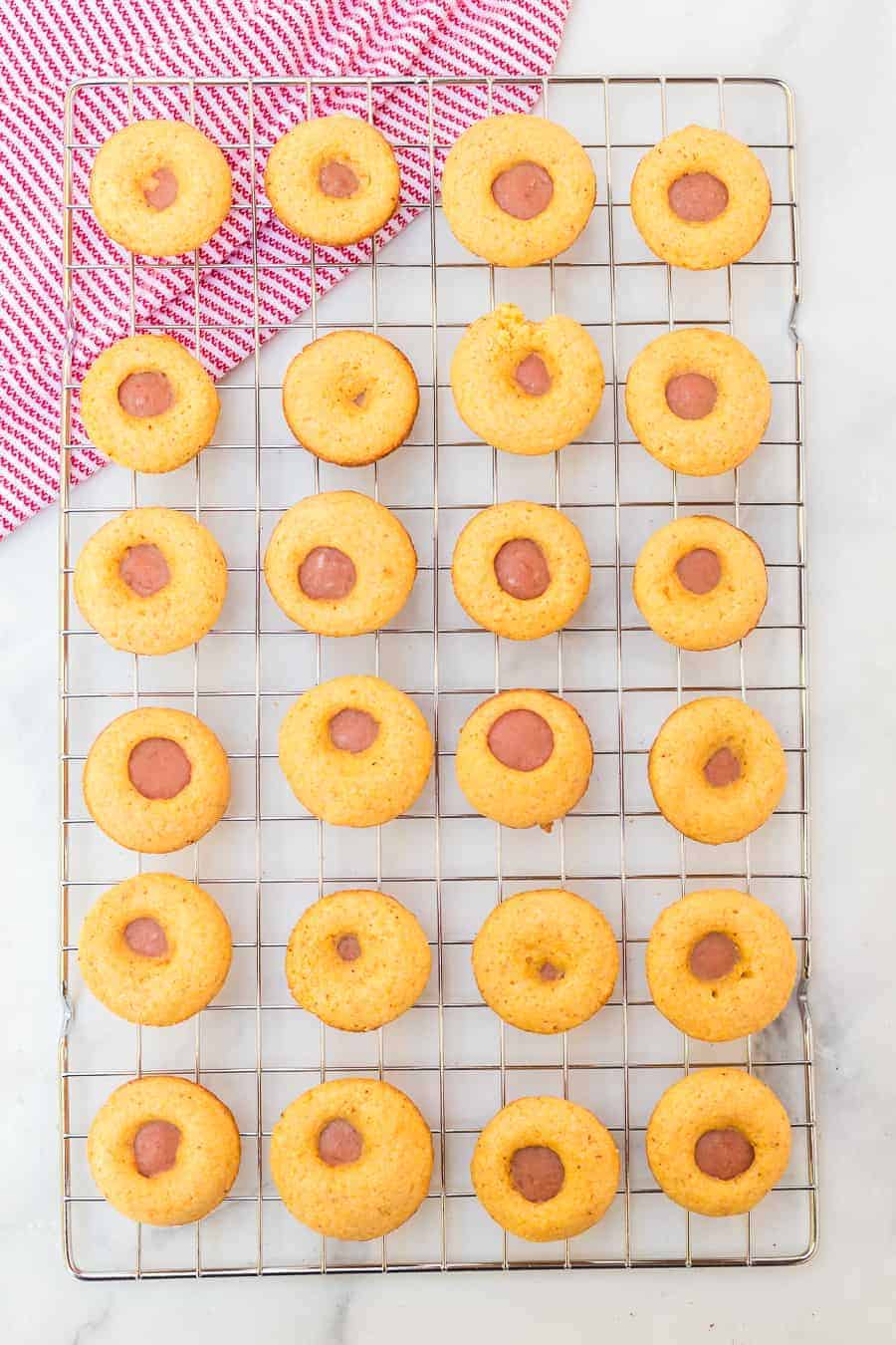 a cooling rack of muffin shaped mini corn dogs.