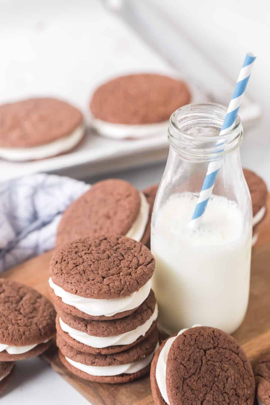 sandwich cookies made with a cake mix next to milk.