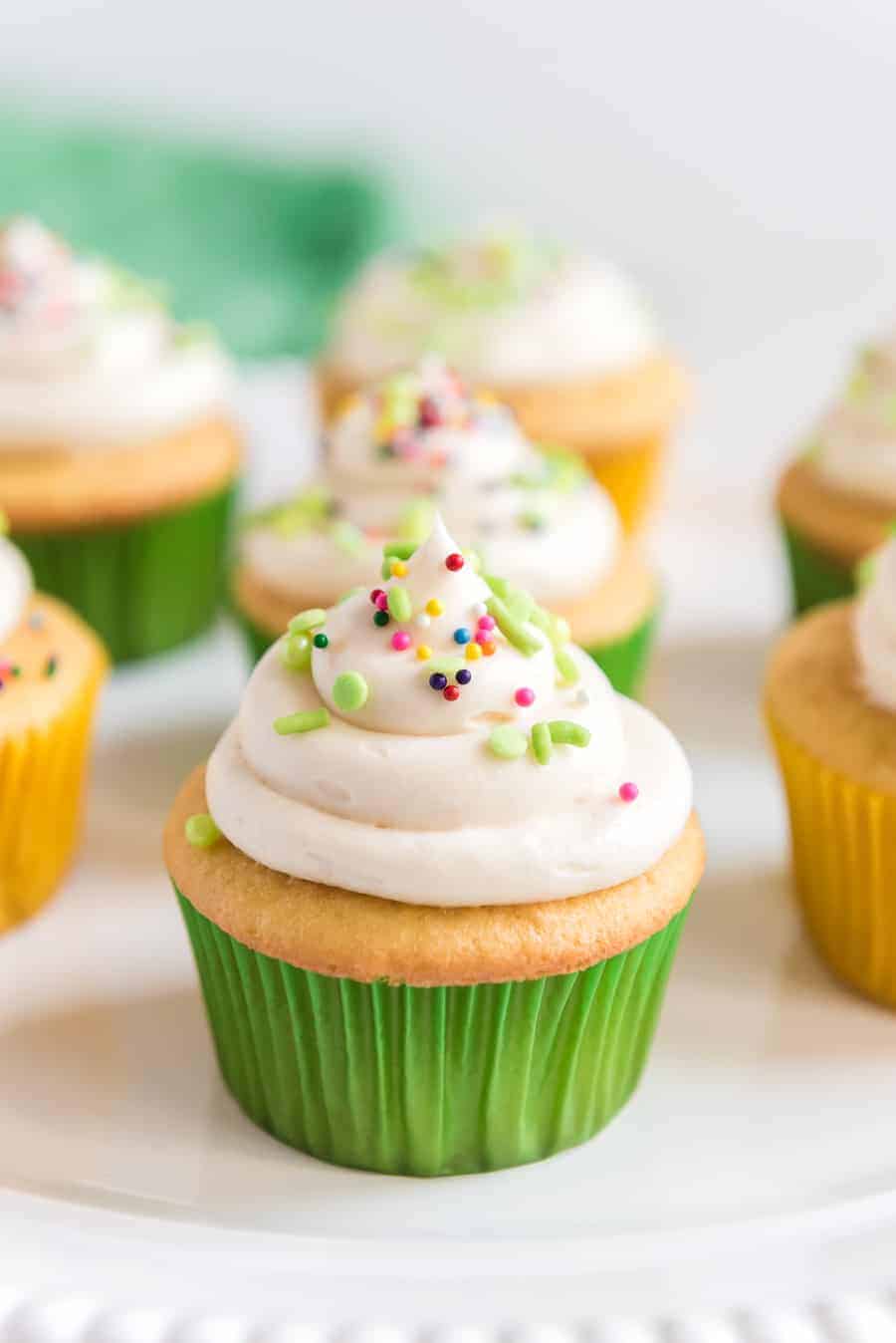 vanilla cupcakes with buttercream icing on top.