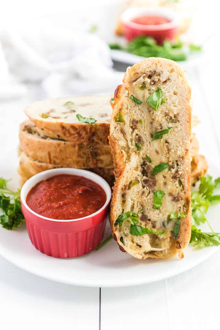 Cheesy Sausage and Pepper Stromboli made with homemade pizza crust, lots of sausage and cheese, and all rolled up into dippable pizza-like slices the whole family will love.