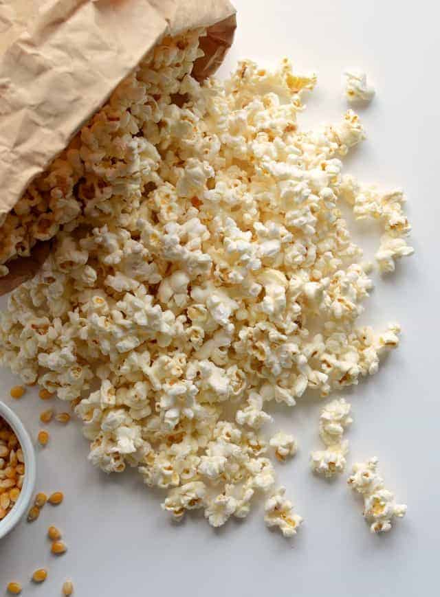 Quick and easy guide on how to pop popcorn in the microwave using just a paper bag, no oil needed.