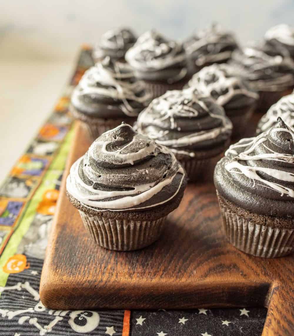 spiderweb cupcakes on a cutting board