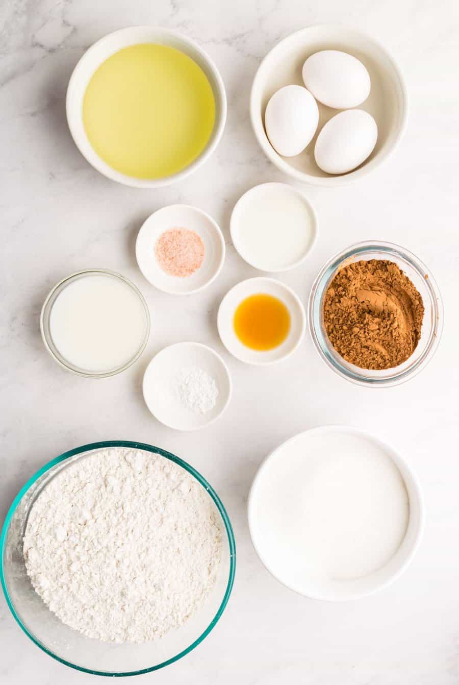 ingredients for cheesecake brownies in separate bowls