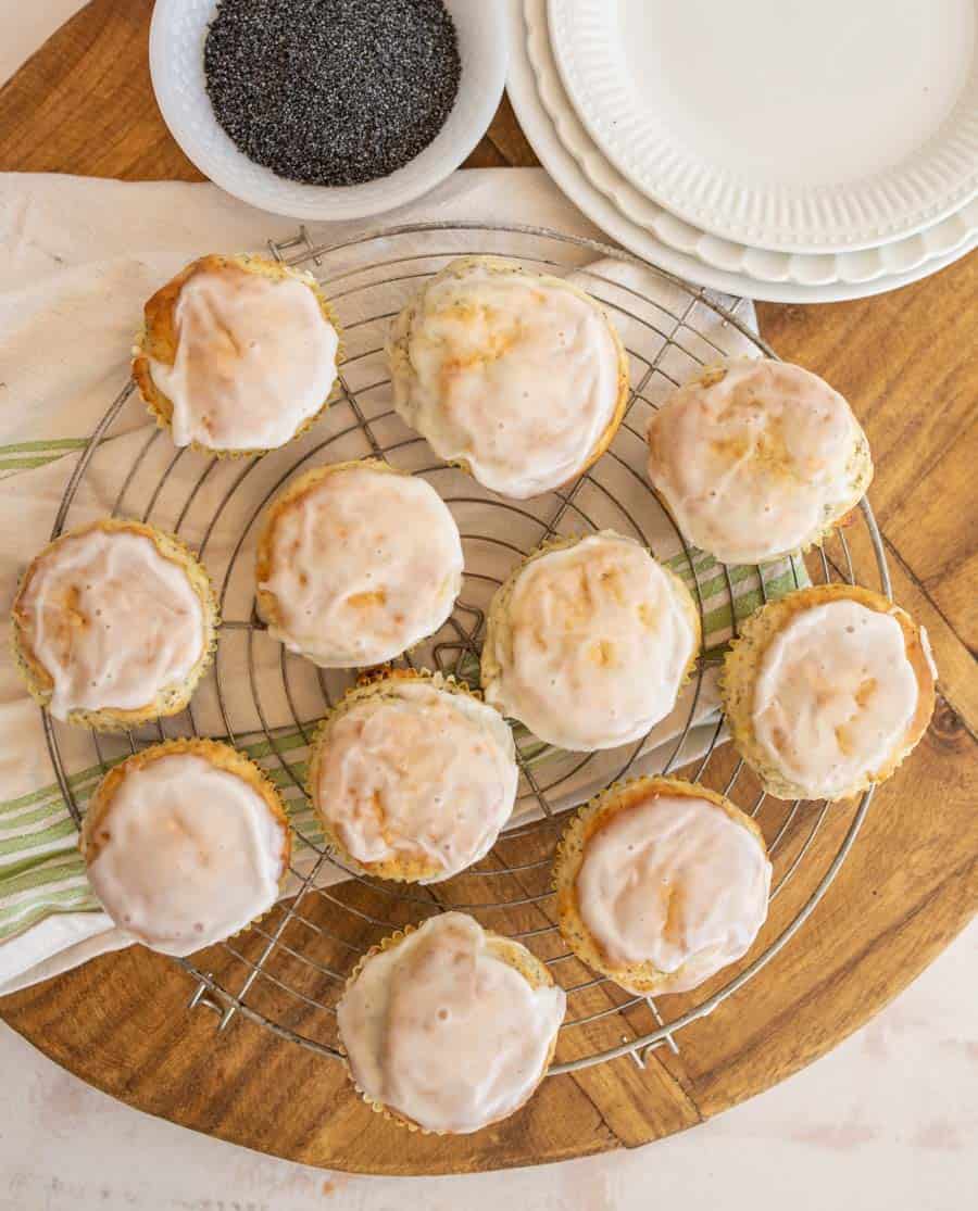 A top view of lemon poppy seed muffins on a wire rack.