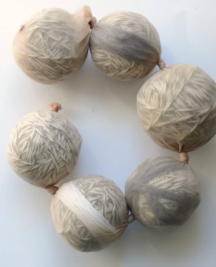 Wool dryer balls in a pantyhose before being felted.