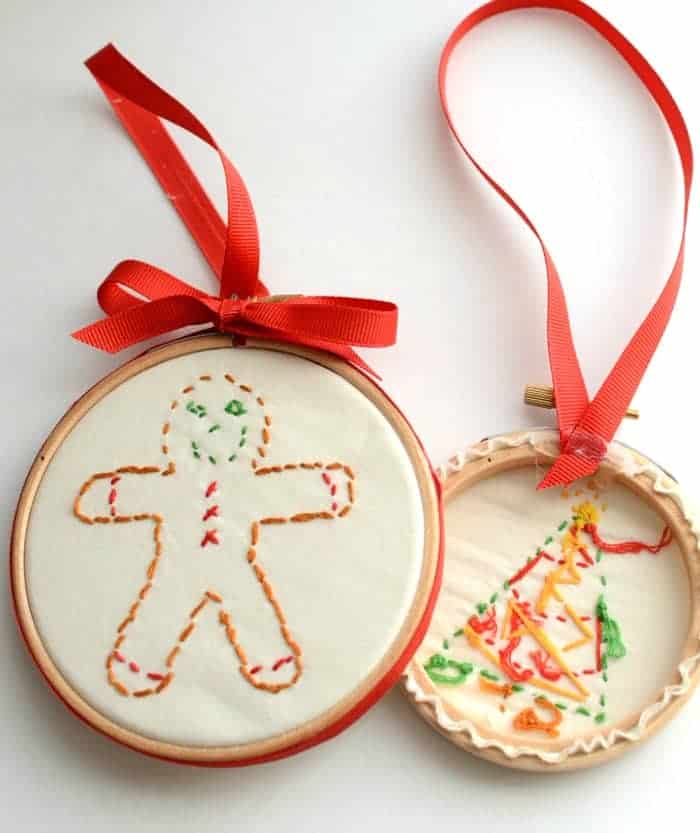 A gingerbread embroidered ornament in a hoop and the back side of a Christmas tree embroidered ornament.