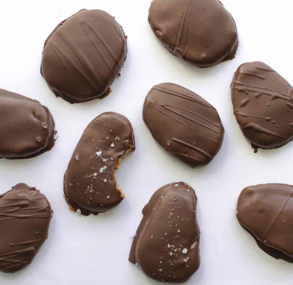Homemade peanut butter eggs, one is missing a bite.