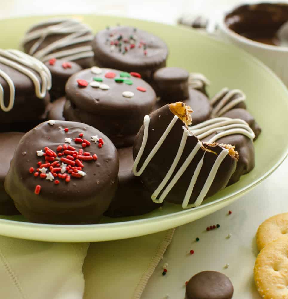 No-Bake Chocolate-Covered Fluffernutter Cookies on a light green plate with a bite taken out of one.