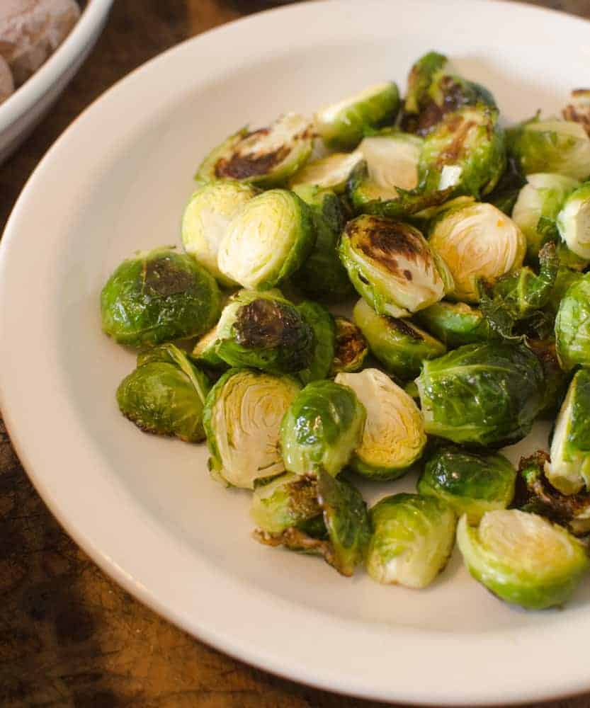 Roasted Brussels sprouts on a white plate.