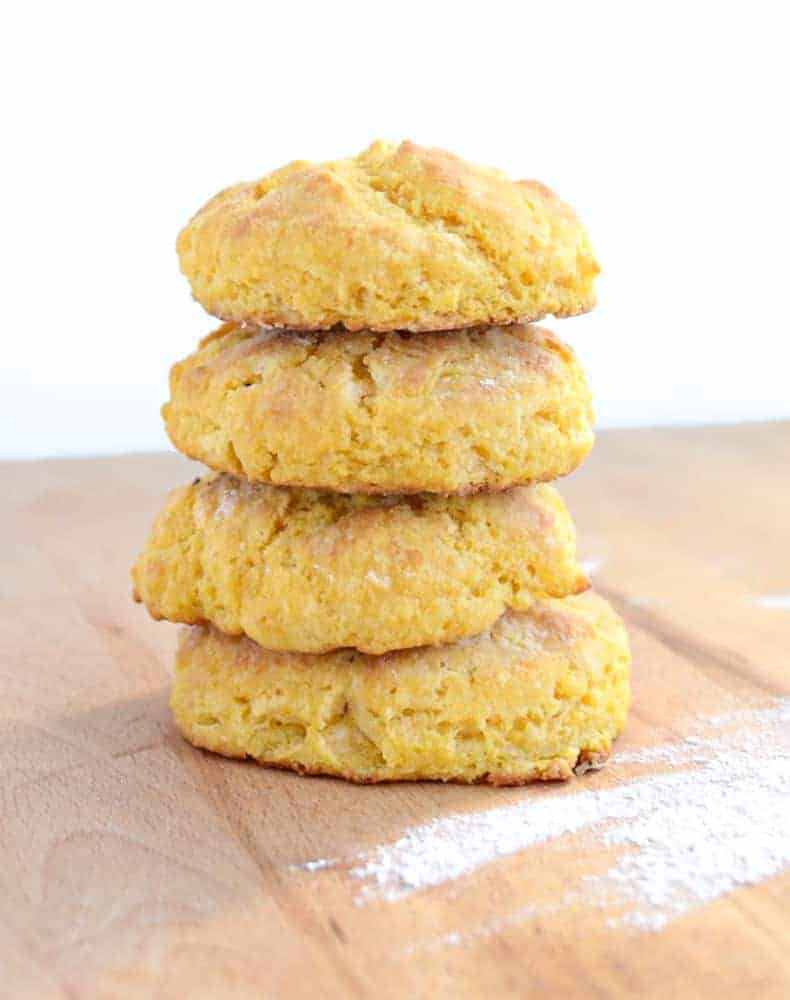 A vertical stack of four sweet potato biscuits showing their fluffy texture.
