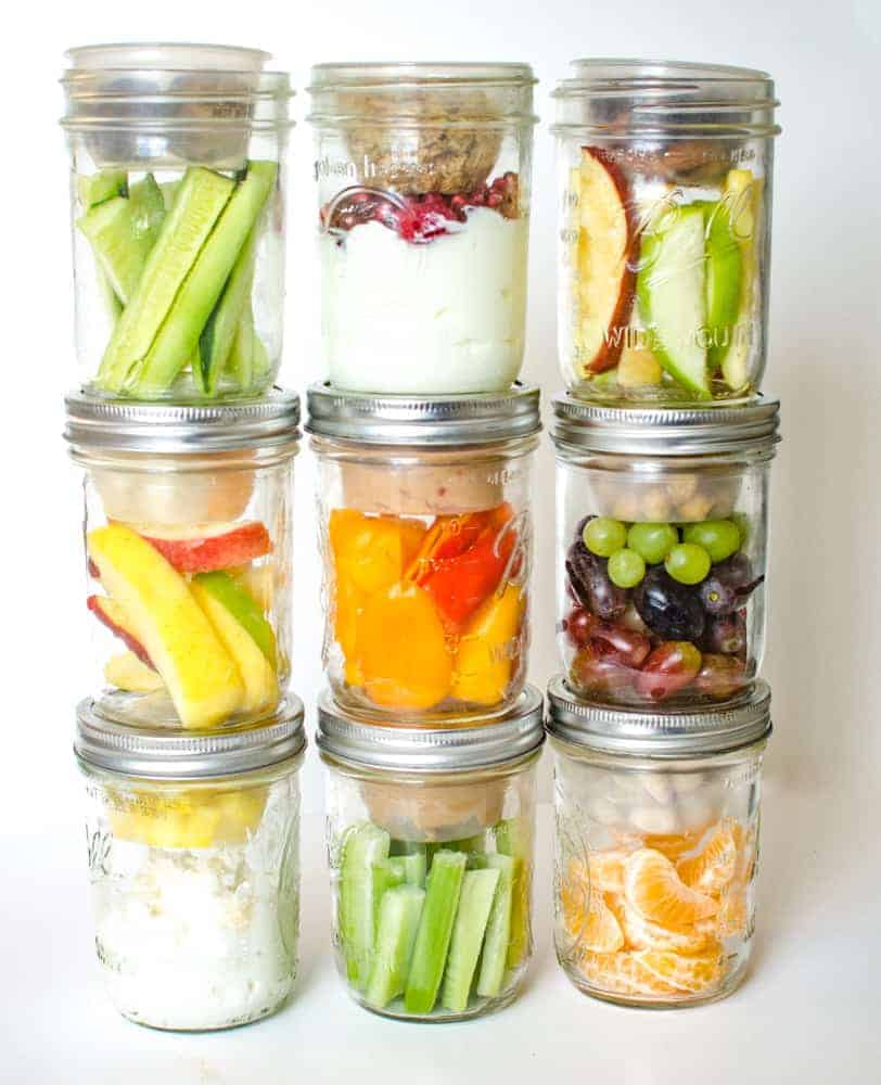 Healthy snacks in pint-sized Mason jars stacked three tall and three wide.