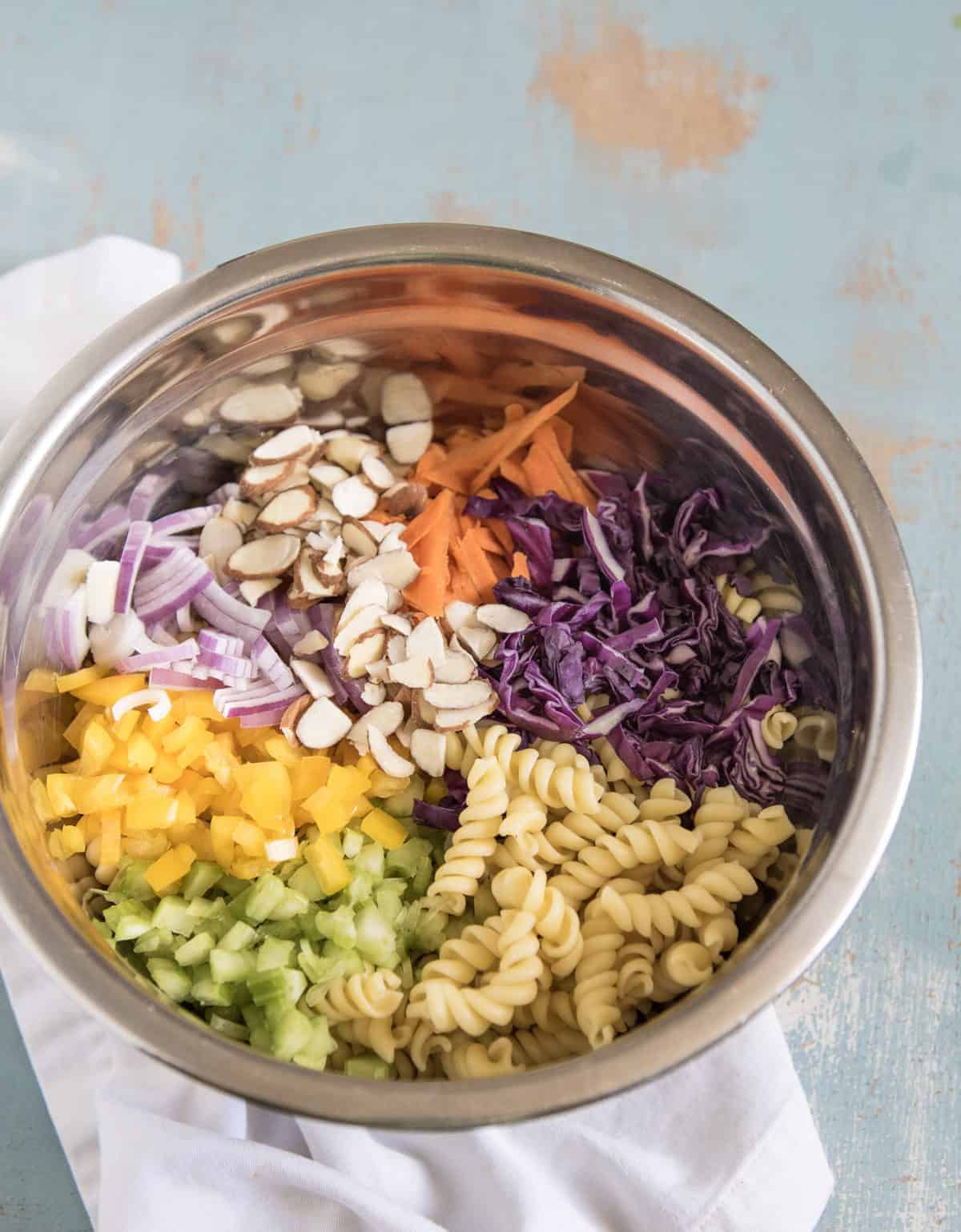 Ingredients of Asian pasta all in a metal bowl.