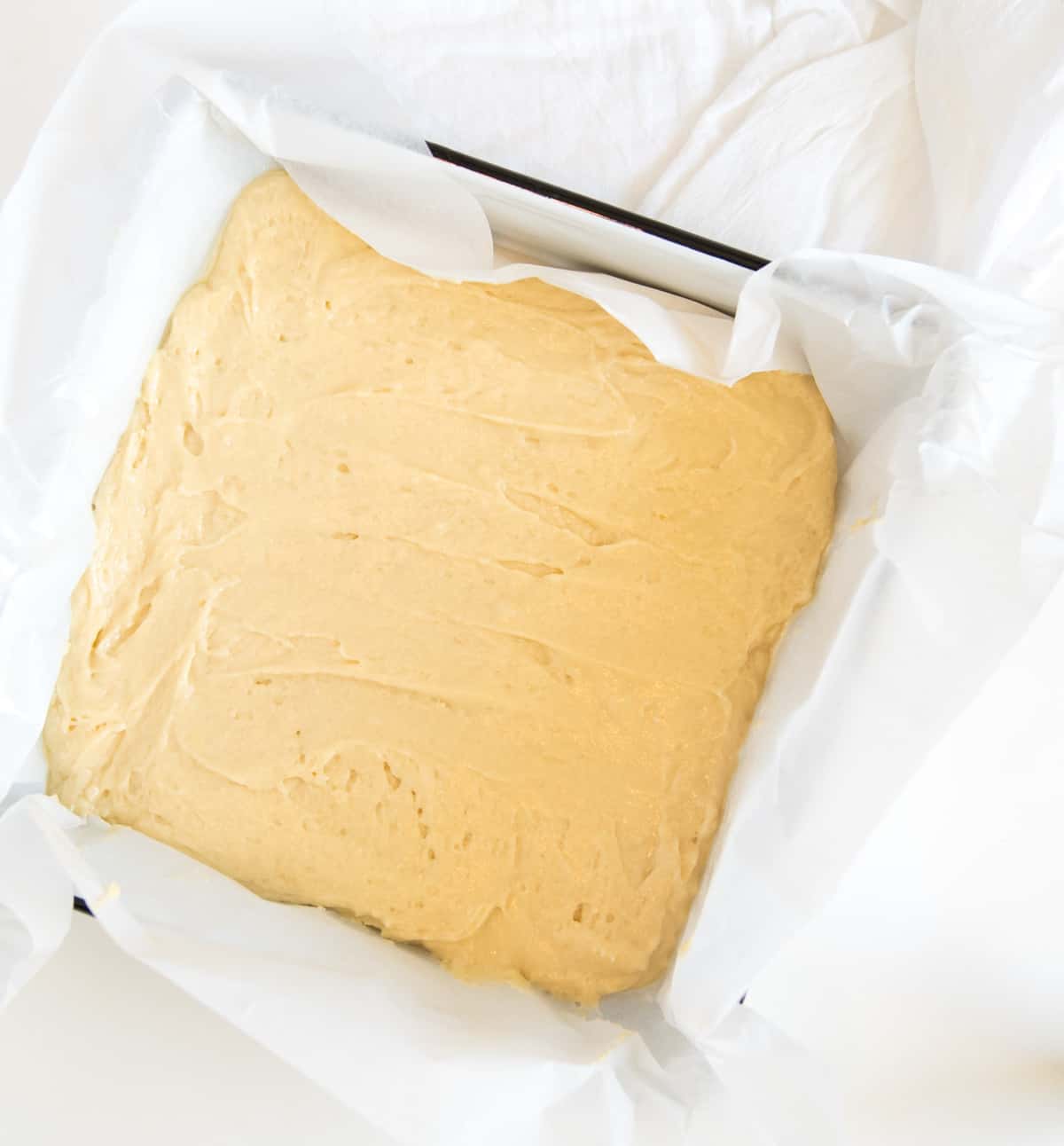 A square pan filled with shortcake dough ready for the oven.