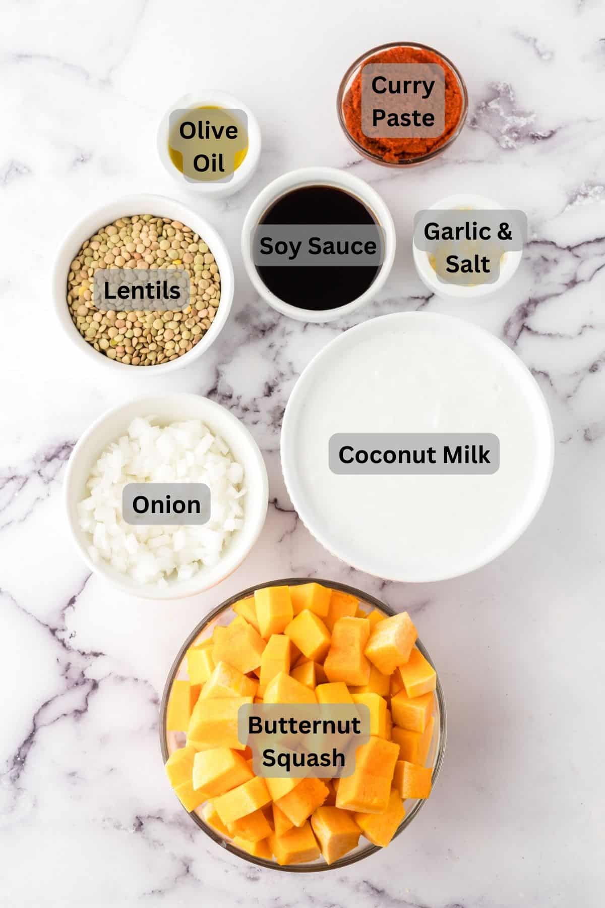 portion bowls each with raw ingredients to make lentil curry recipe.