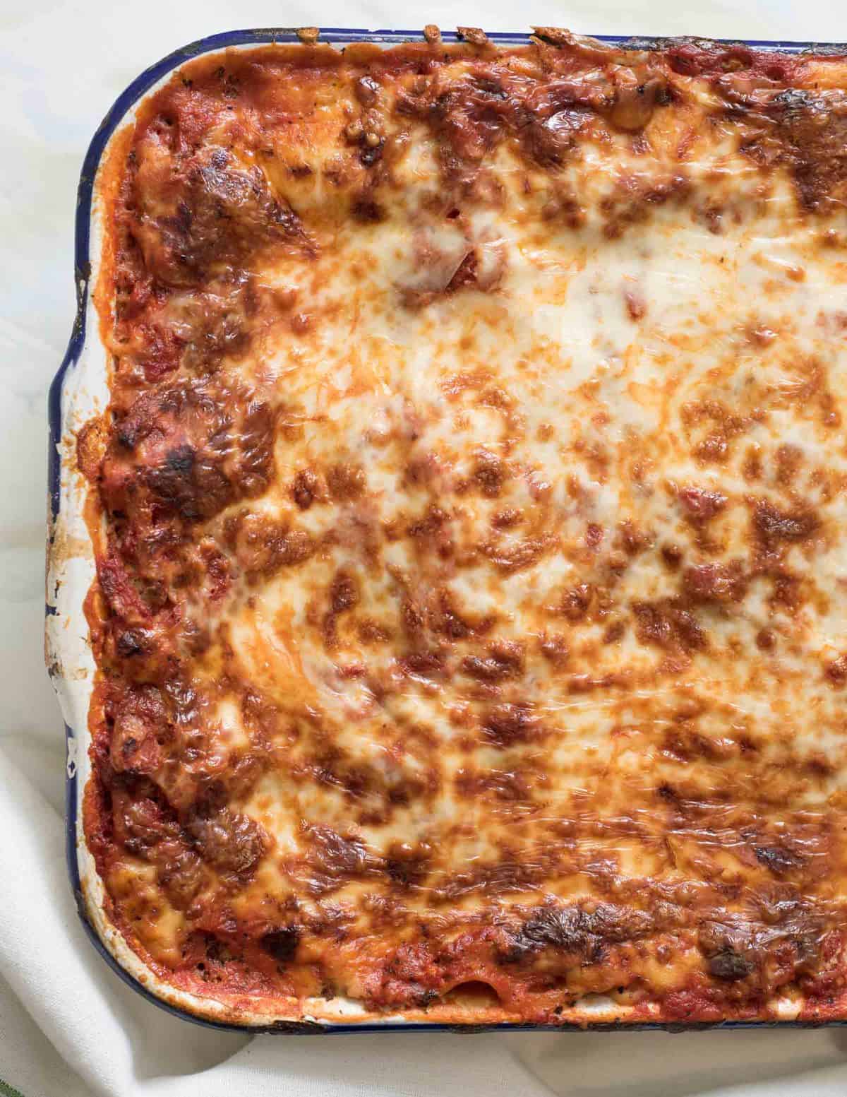 Make-ahead lasagna baked in a white 9 by 13 inch pan.