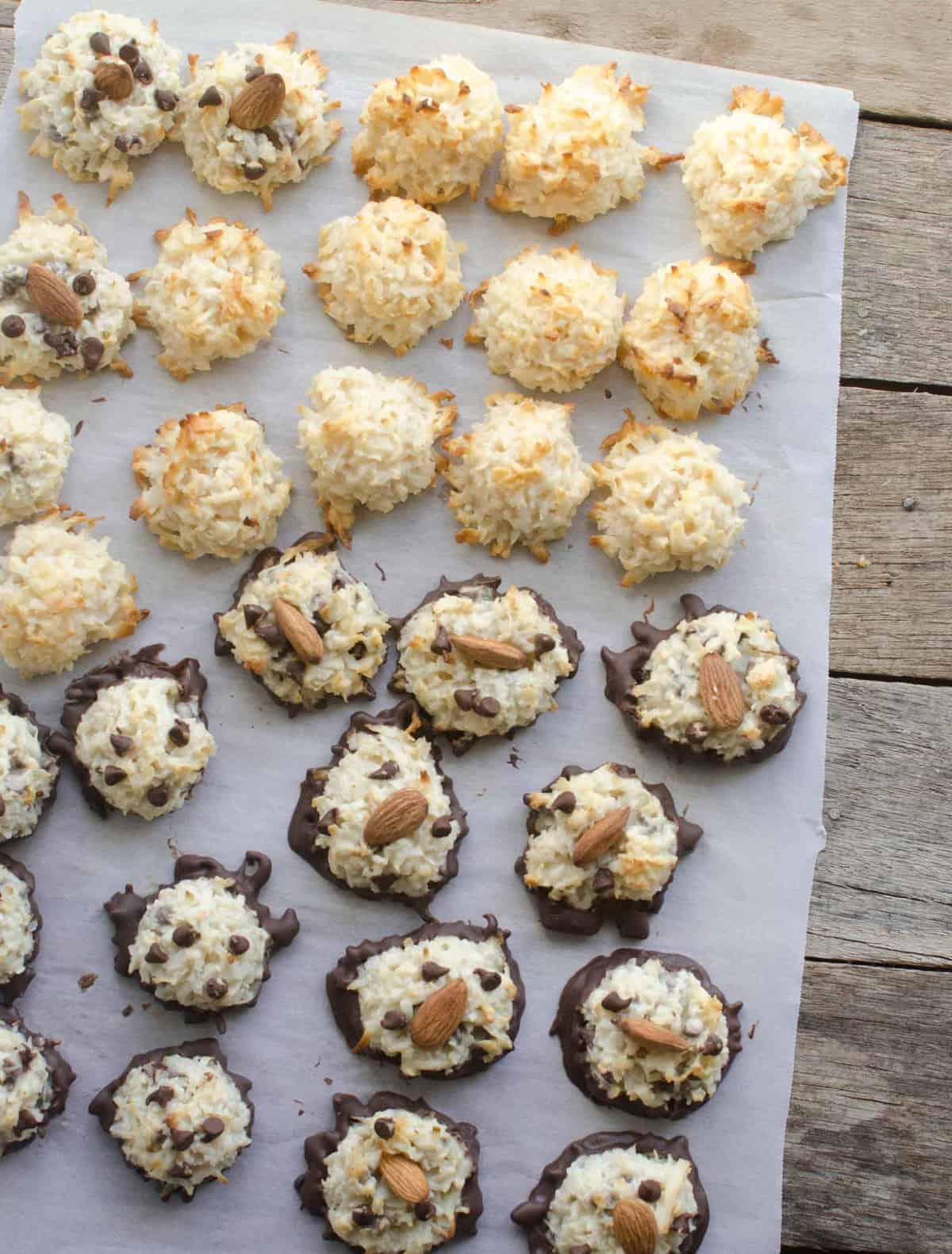 Top view coconut macaroons in three varieties on white parchment paper.