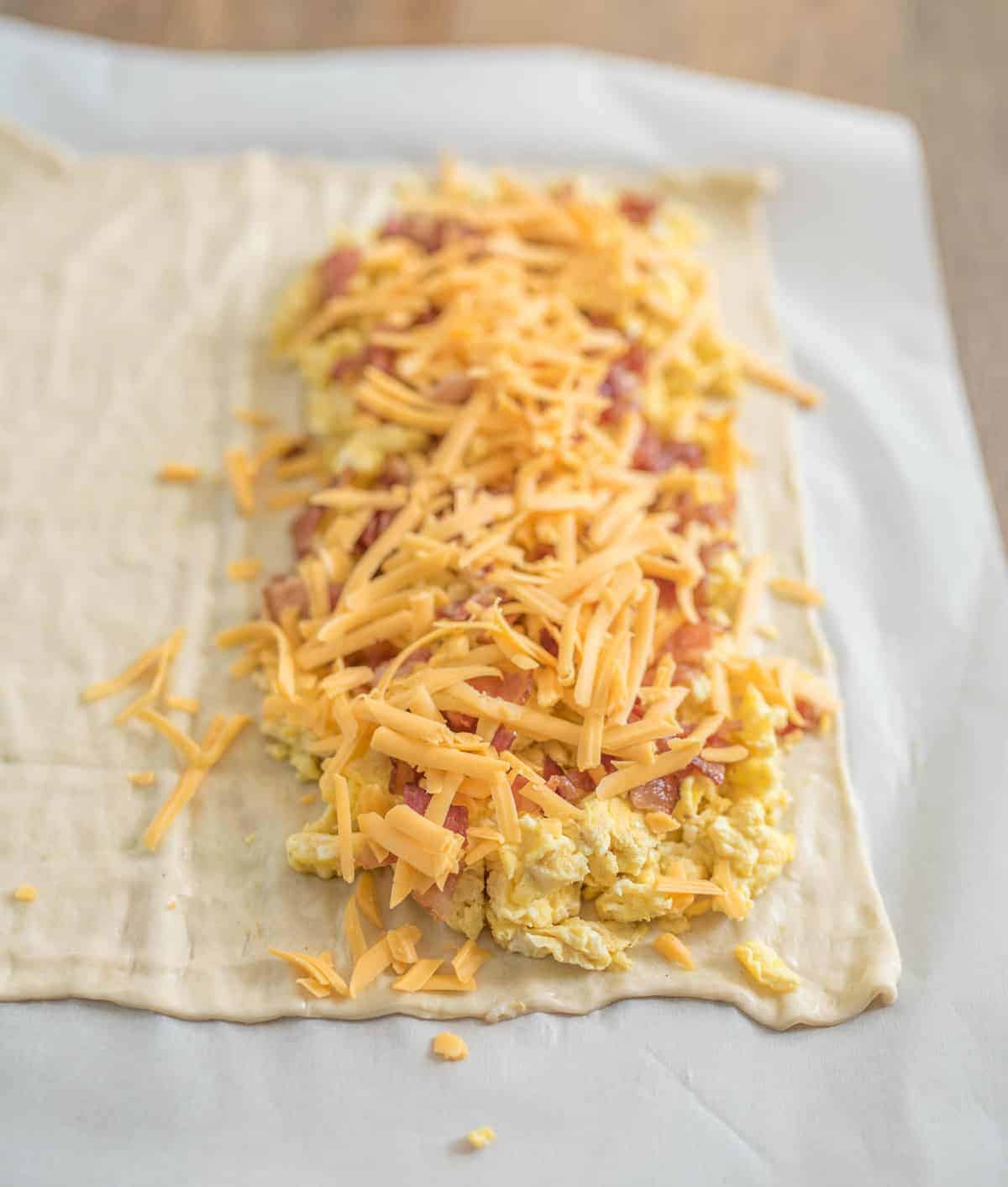Quick and easy breakfast pizza sticks made with pizza dough, eggs, bacon, and cheese, all baked into easy to eat pizza sticks.