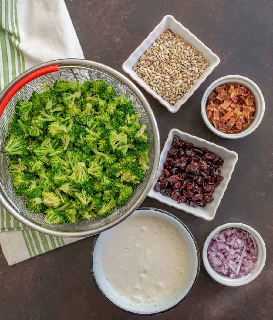 Deli-Style broccoli salad made with all your favorites like bacon, onion, cranberries, and more, plus a secret tip!