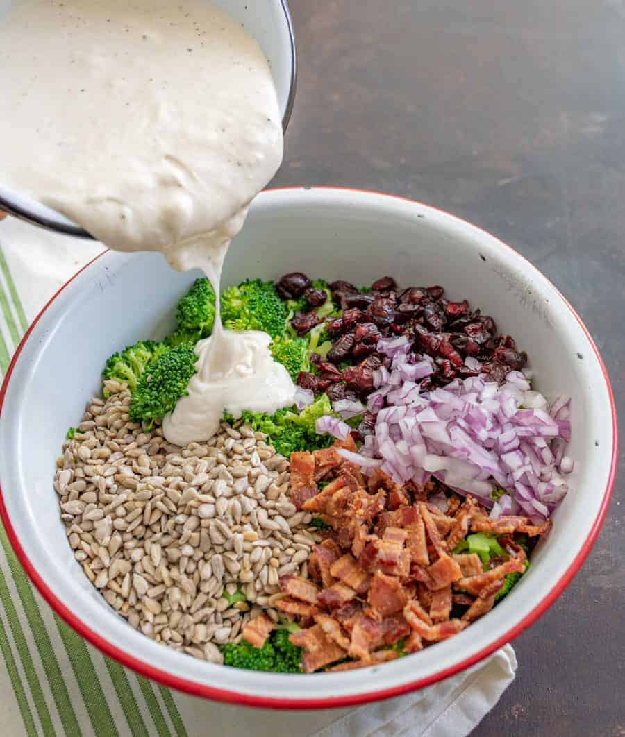 Deli-Style broccoli salad made with all your favorites like bacon, onion, cranberries, and more, plus a secret tip!