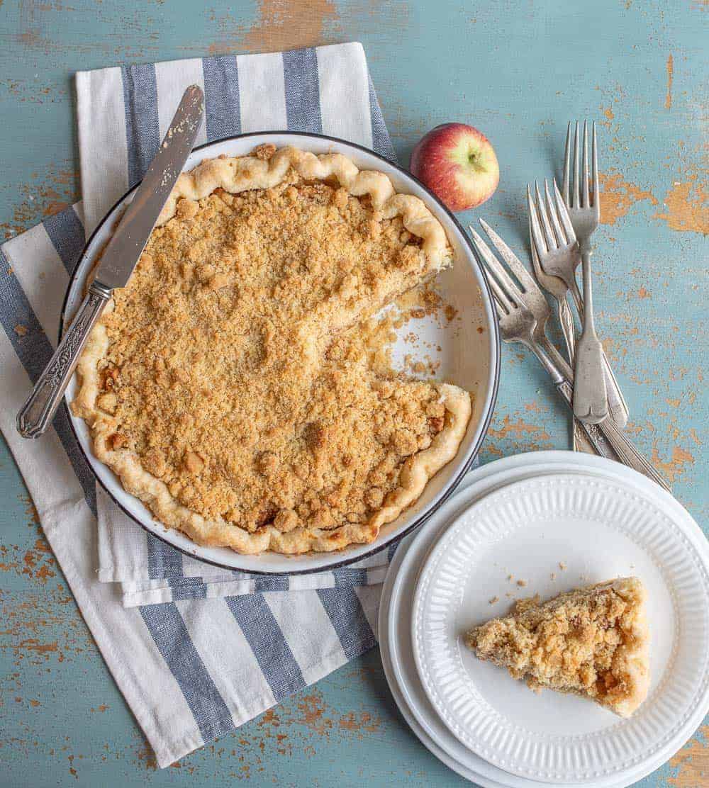 Image of a Dutch Apple Pie with One Slice on a Plate.
