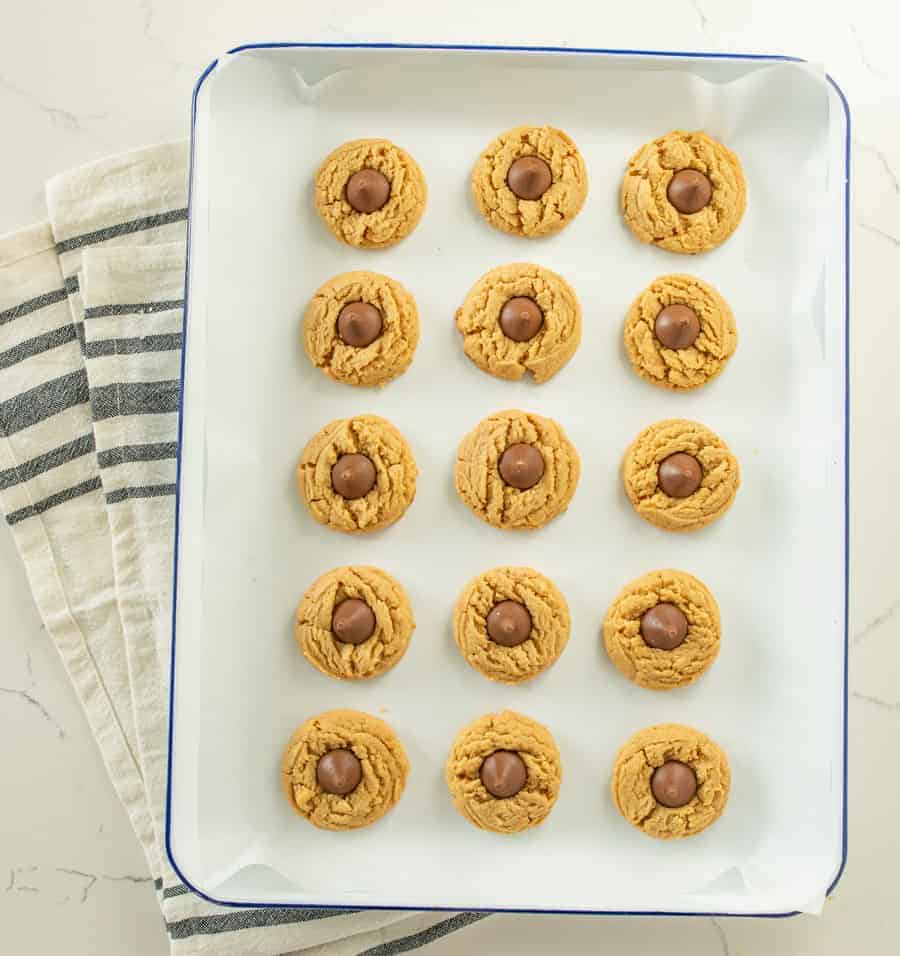 The best peanut butter blossoms made with a thick, soft, and chewy peanut butter cookies and a chocolate kisses pressed in the middle.
