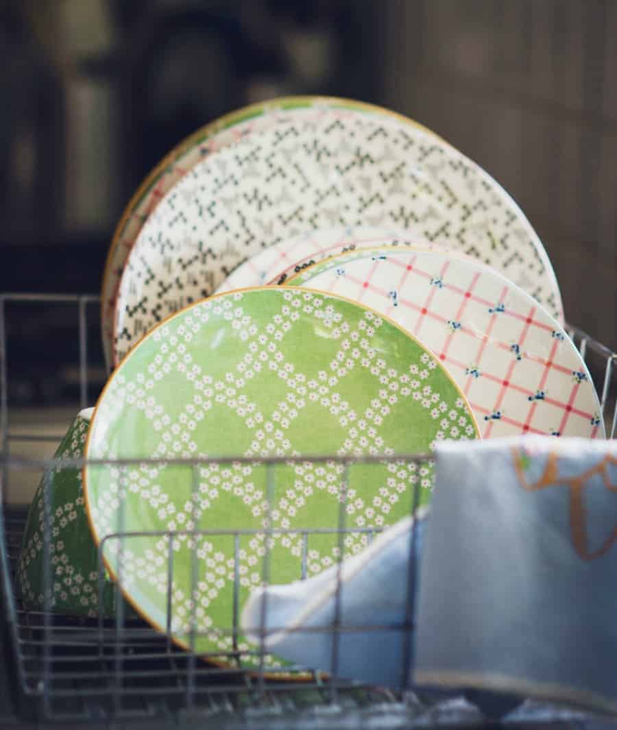 Image of clean dishes in a dish rack.