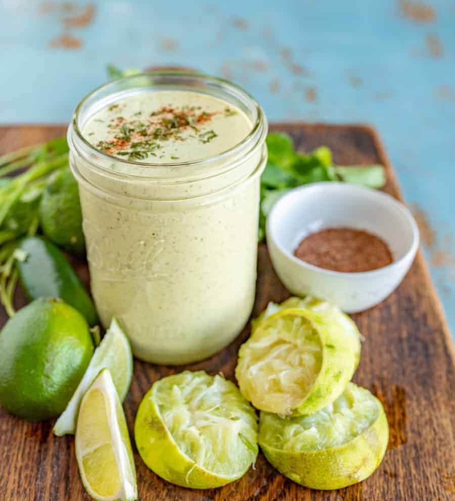 Creamy Cilantro Lime Dressing made with green salsa, mayo & herbs. Perfect for your favorite taco salad or on nachos! Just throw it in the blender and go!