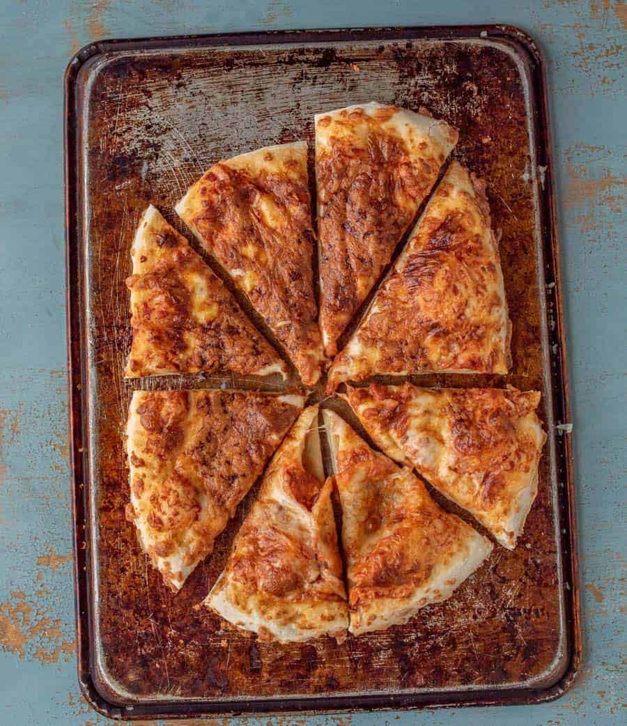 an overhead shot of no-knead refrigerated pizza dough on a pan. Baked until golden brown.