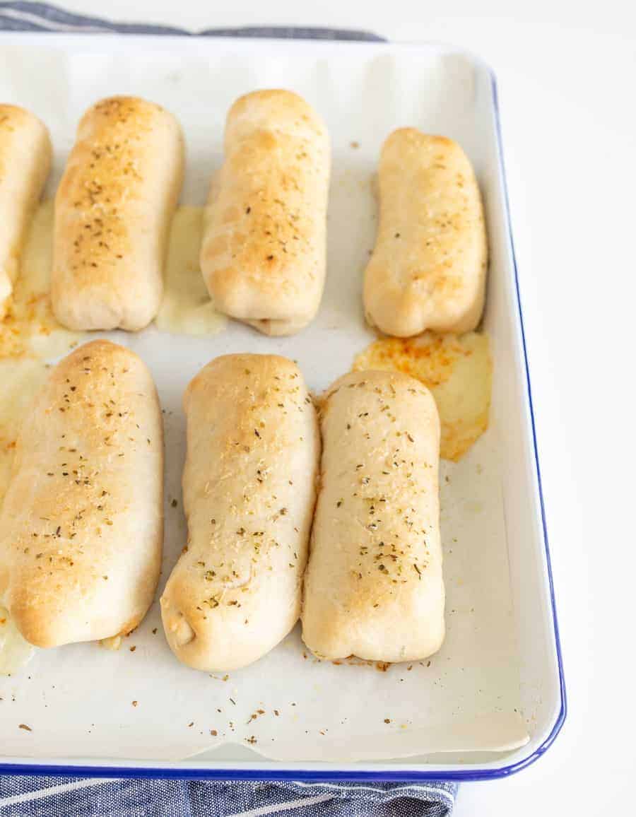breadsticks on a white pan.