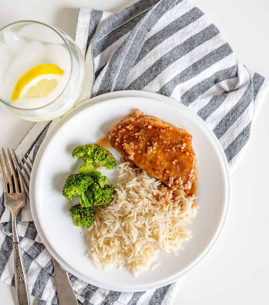 Vibrant and hearty, Slow Cooker Honey Garlic Pork Chops come together super fast with minimal ingredients--pork chops, salt and pepper, garlic, honey, soy sauce, and ketchup--and a few hours of cook time in the slow cooker.
