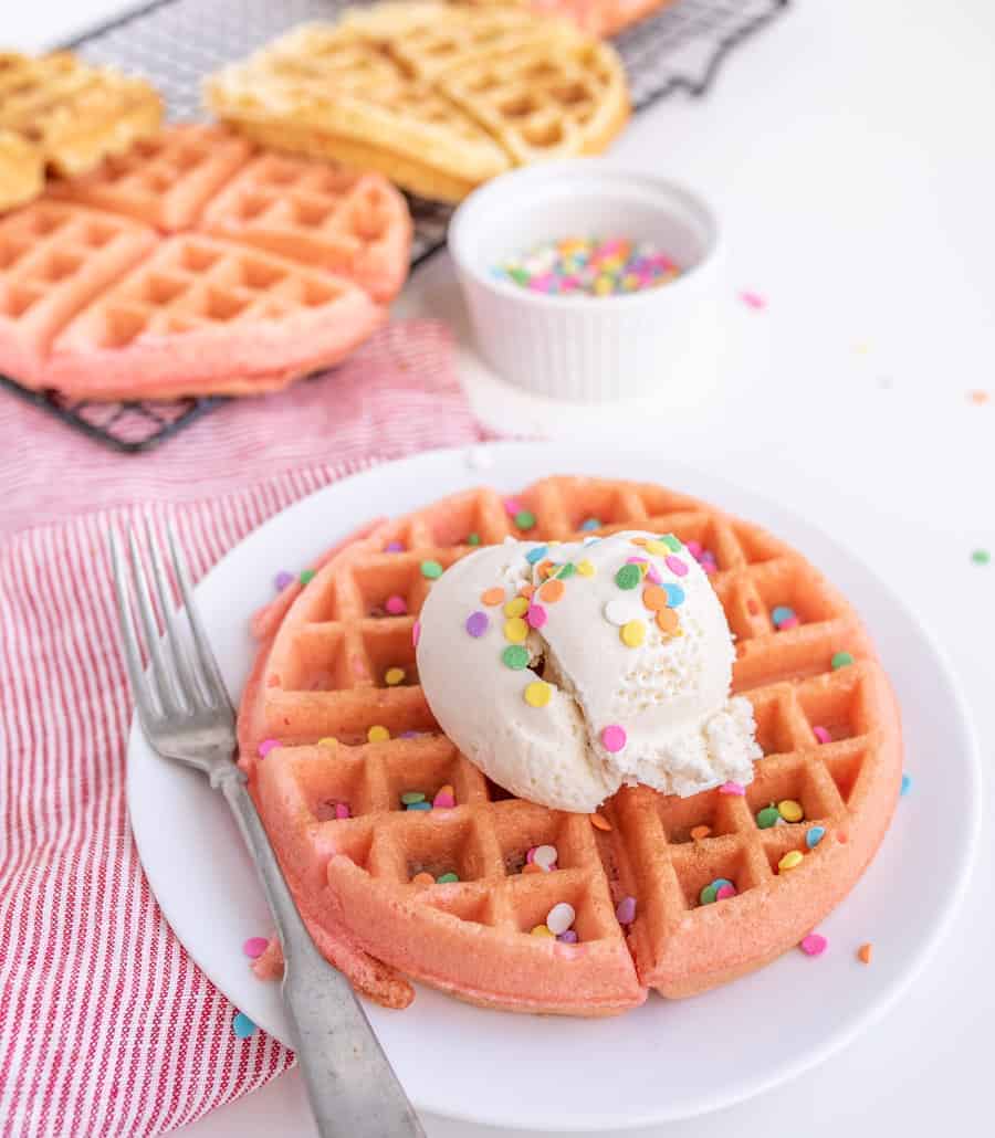 cake batter waffles with sprinkles and whipped cream.