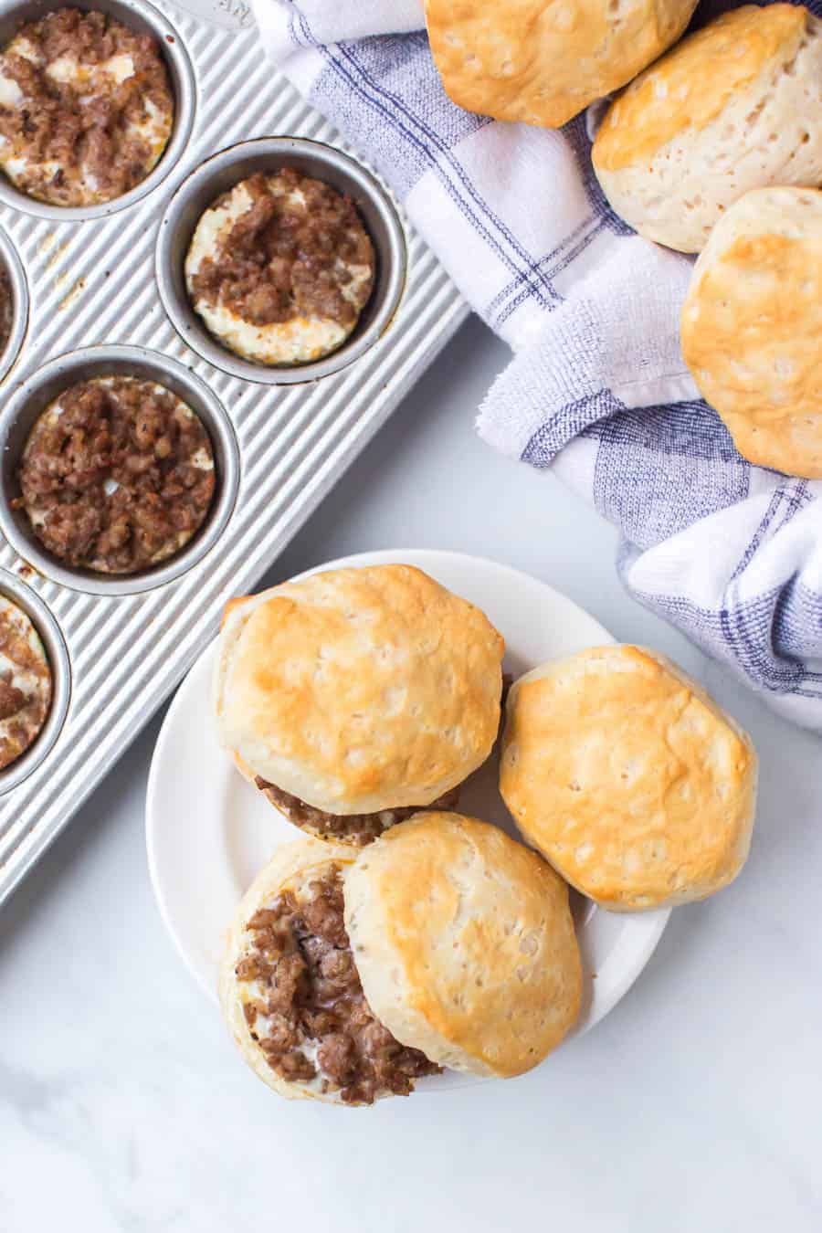a plate of home made biscuits with ground sausage in the middle