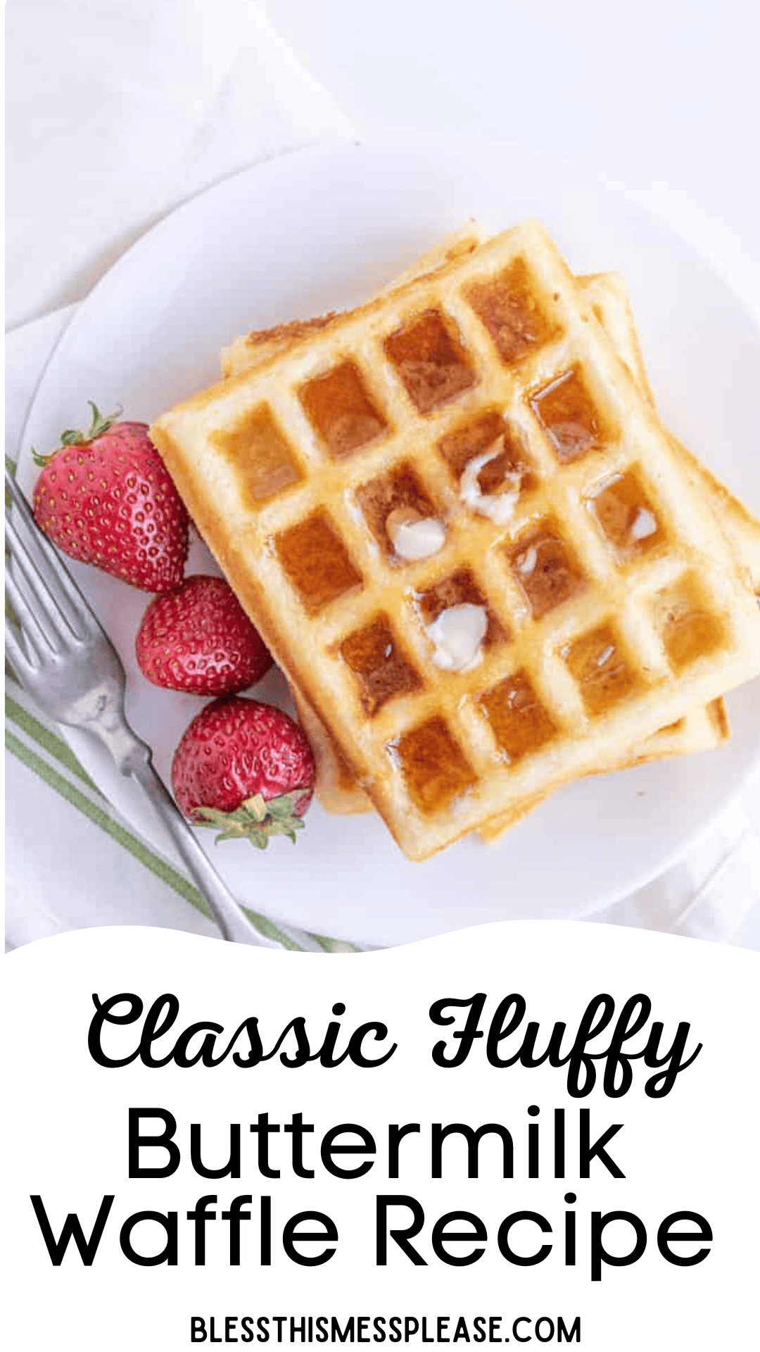 A plate of two golden, fluffy buttermilk waffles with a pat of butter melting on top, served with fresh strawberries on the side. A fork rests on the plate. Text at the bottom reads Classic Fluffy Buttermilk Waffle Recipe.