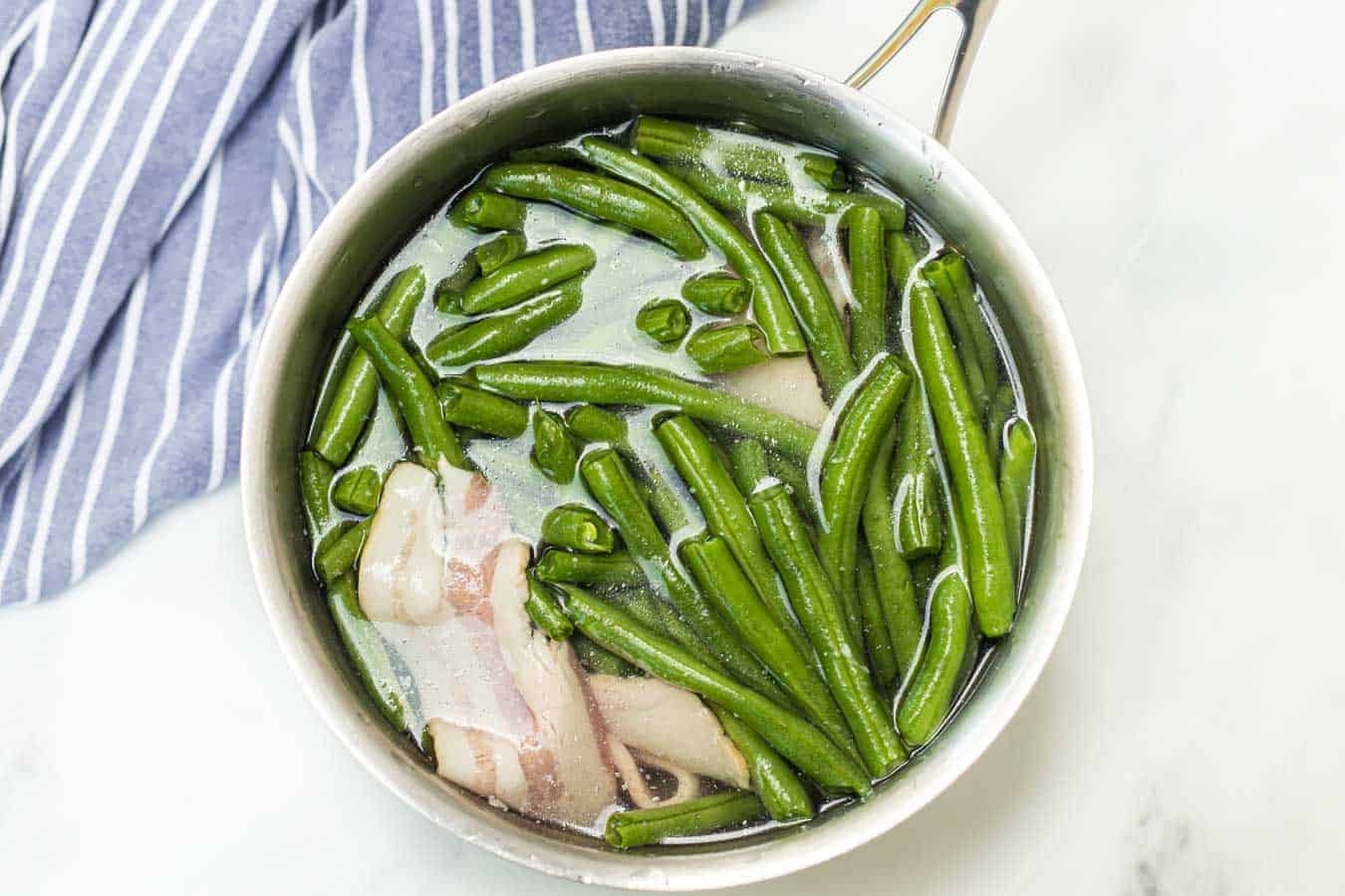 Green beans with butter and bacon is a hearty and flavor-filled side dish that takes green beans from plain to irresistible with just a handful of ingredients.
