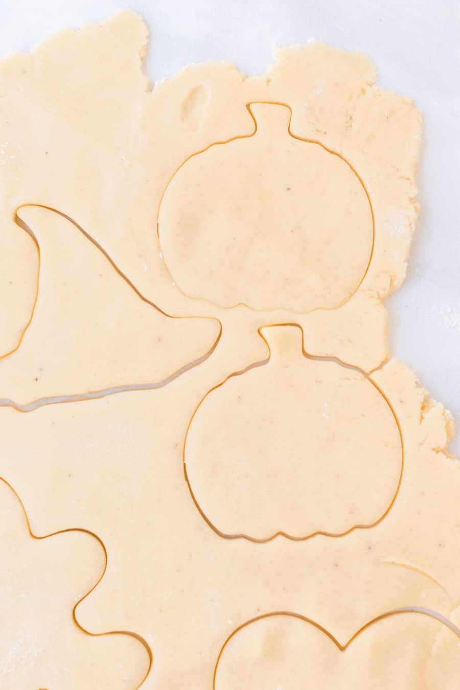 cookie dough with pumpkin and witch hat cut out.