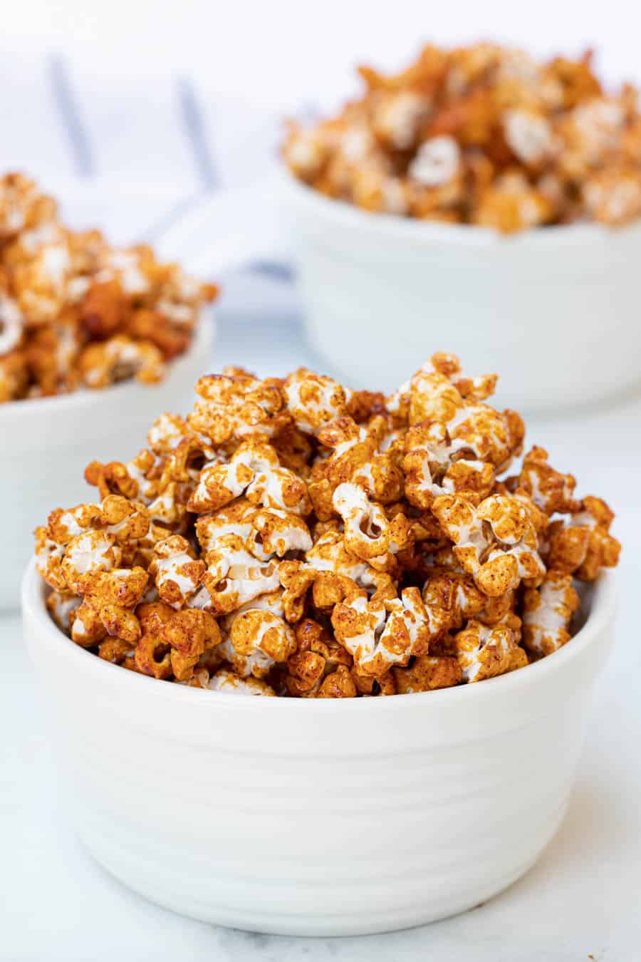 honey caramel corn in white bowls.