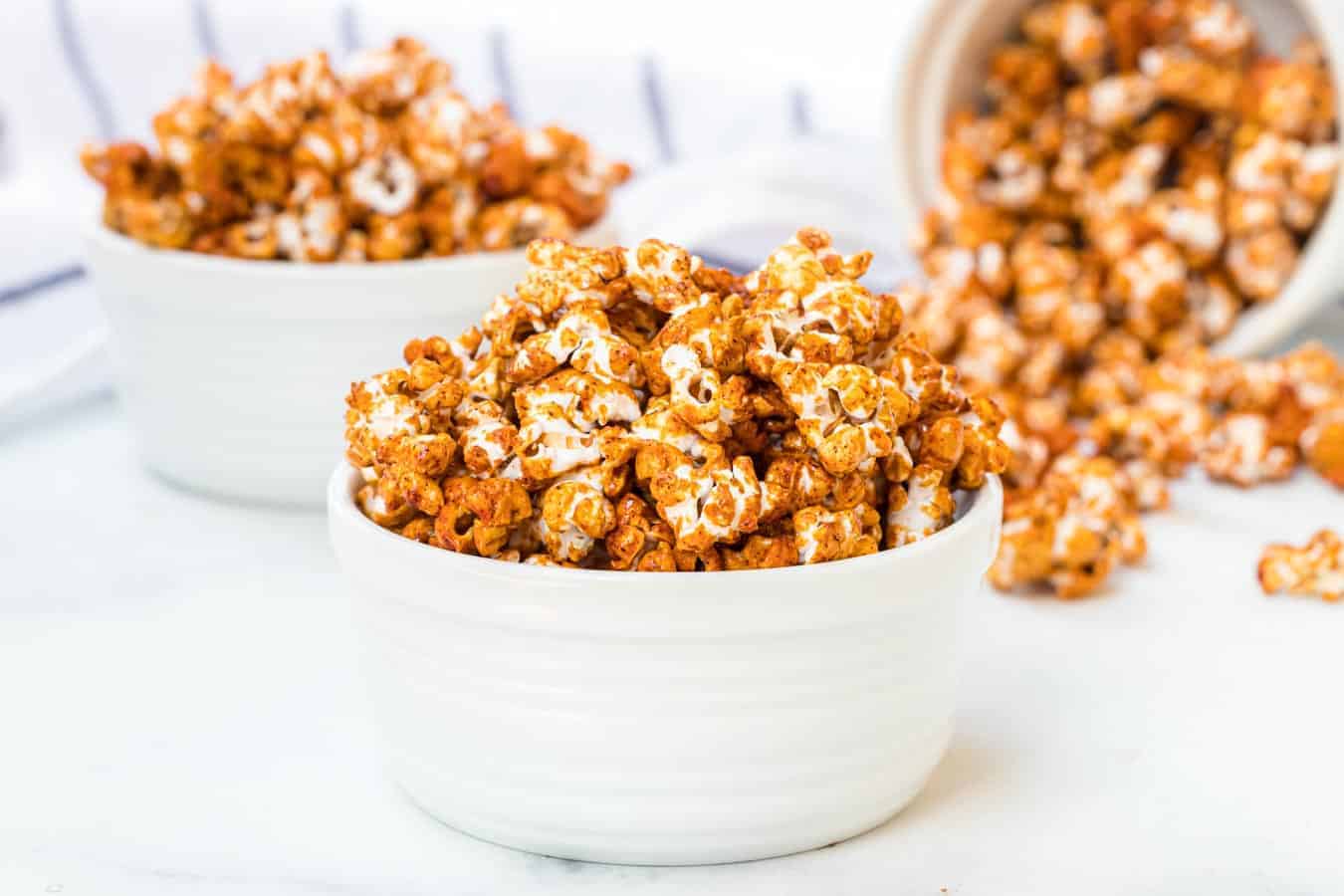 honey caramel corn in white bowls.