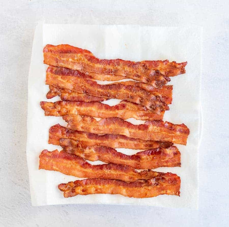 Top view of lots of bacon on a paper towel.
