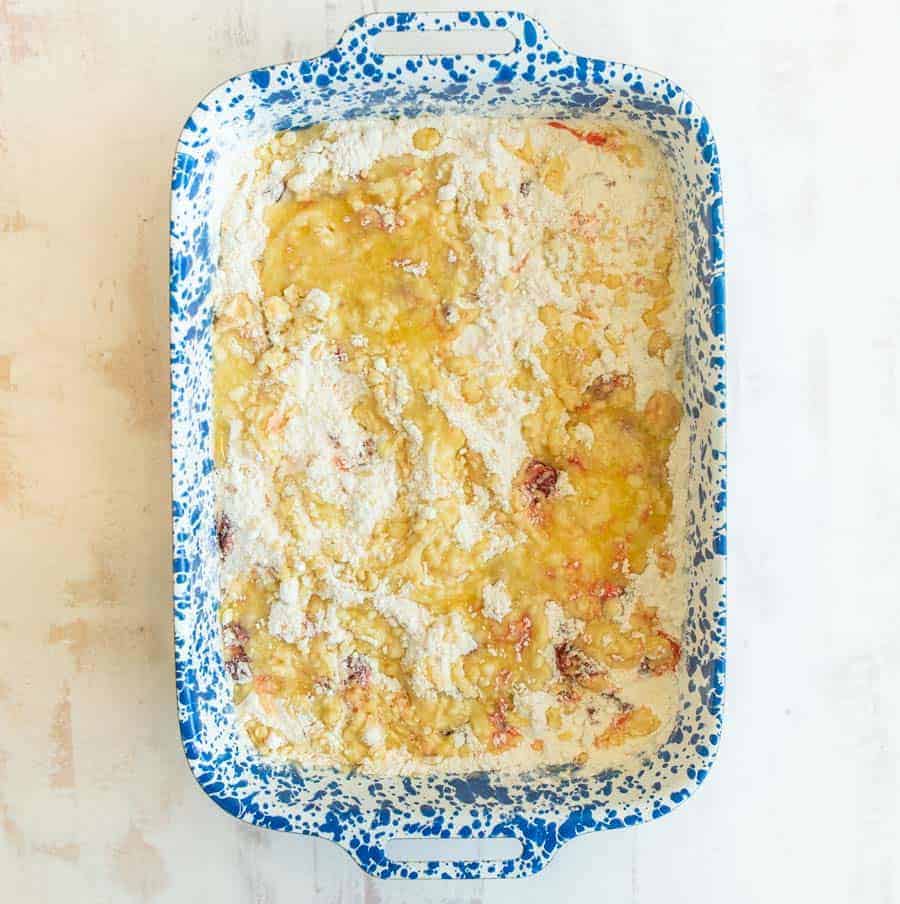 top view of cherry dump cake in a white and blue baking dish.