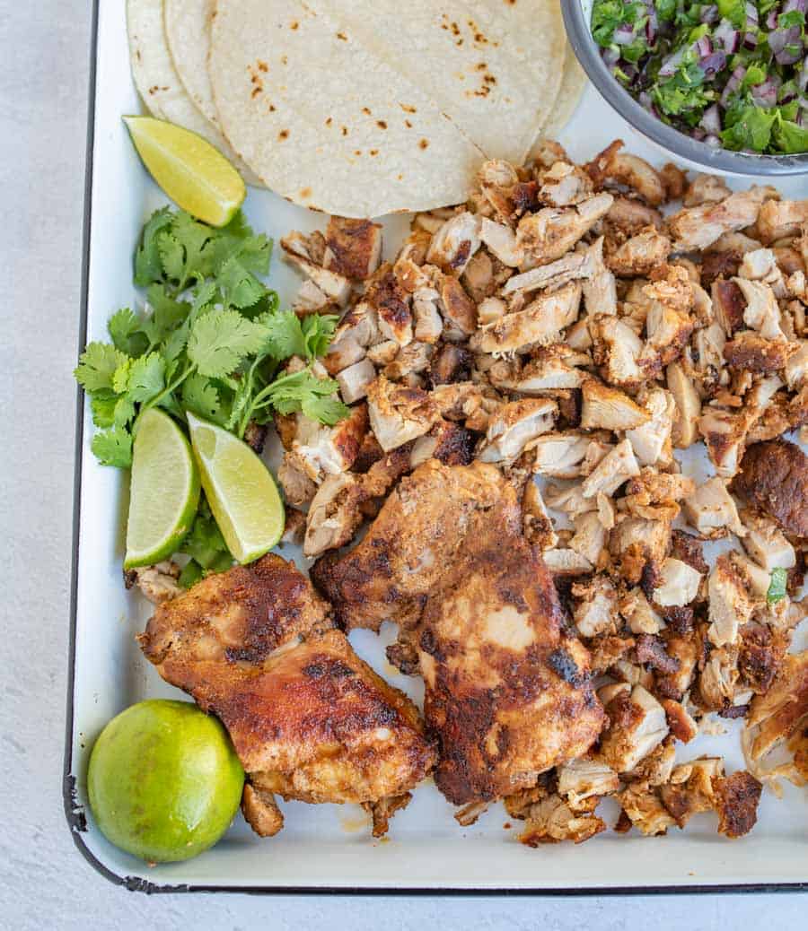 chicken tacos ingredients on white tray.