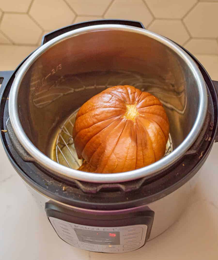 Small orange cooked pumpkin in an instant pot.