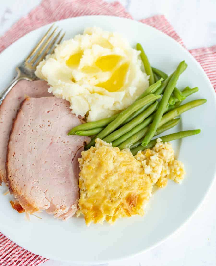 mashed potatoes ham green beans and corn pudding.