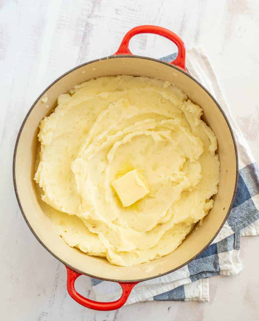 close up of mashed potatoes with melting butter on top.